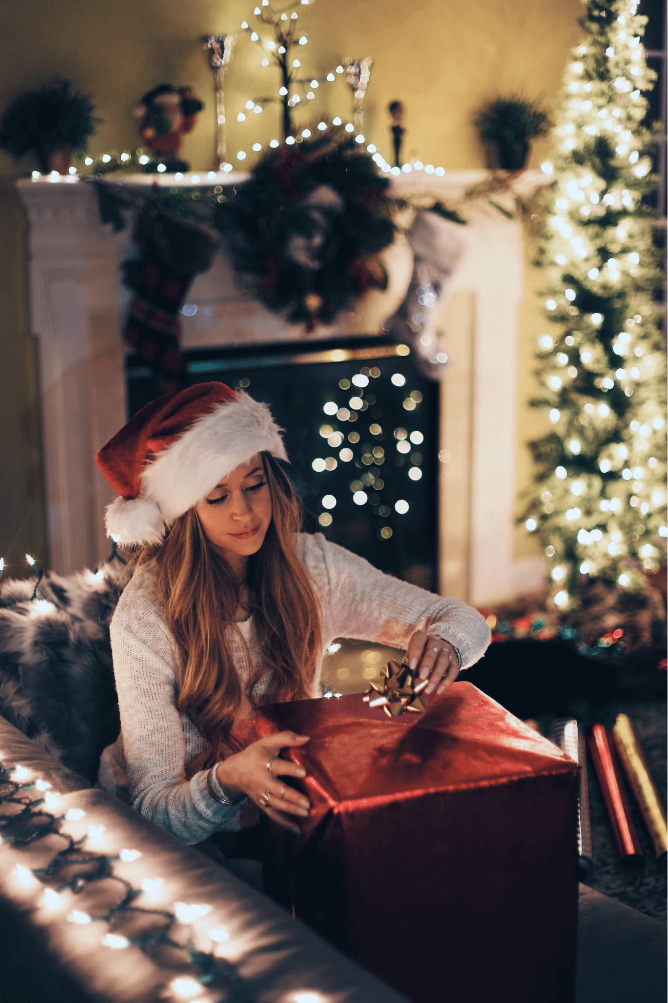 Woman opening a gift on Christmas Eve